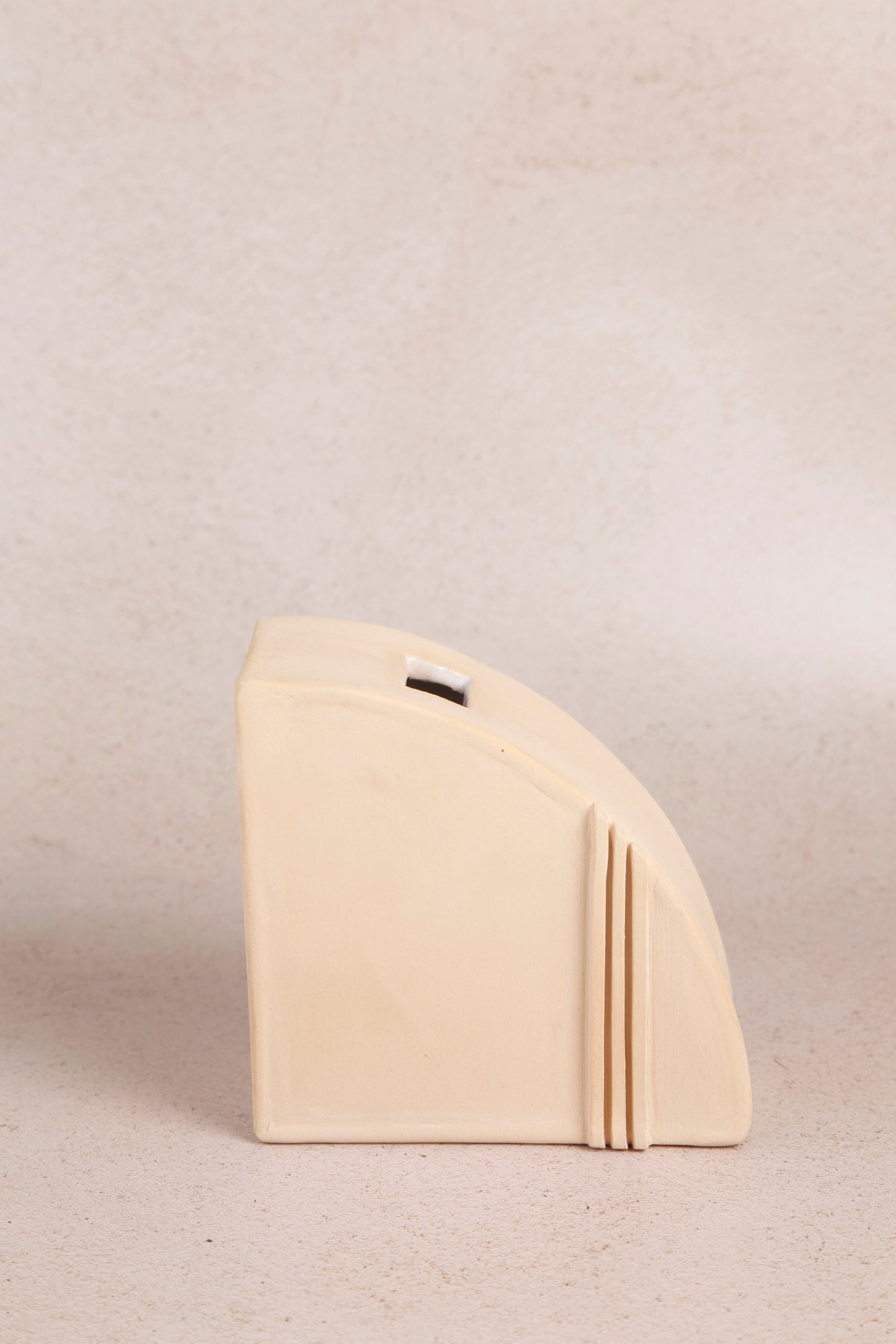 Fin, a ceramic book holder and vase in beige